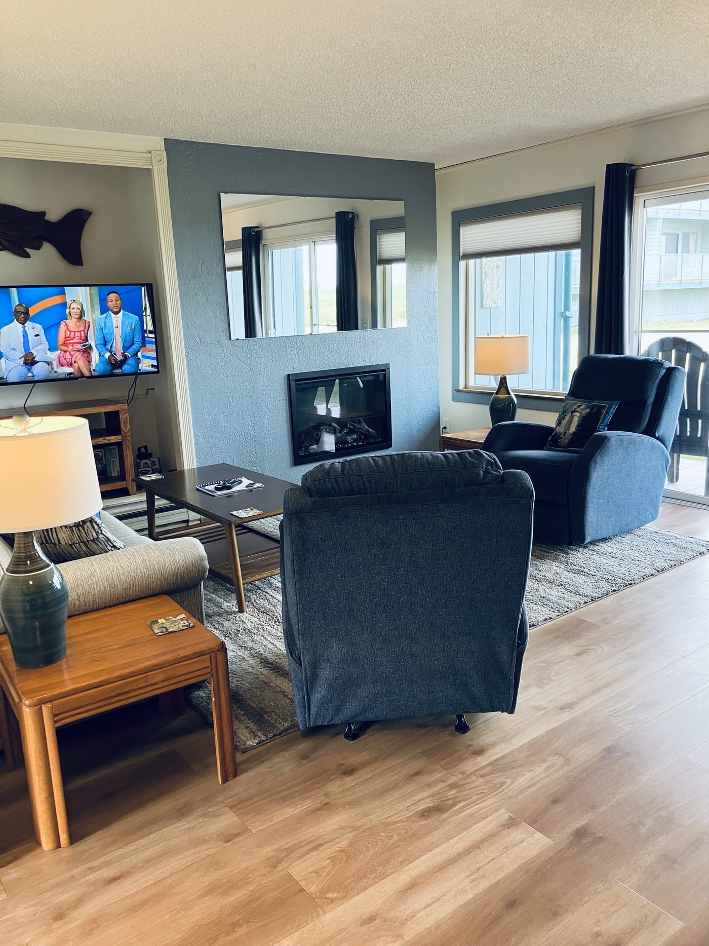 Living room seating with fireplace and TV nook in Unit 01 at Hi-Tide Resort